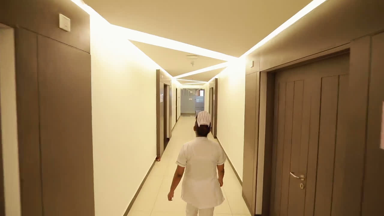 A nurse walking down a hospital hallway