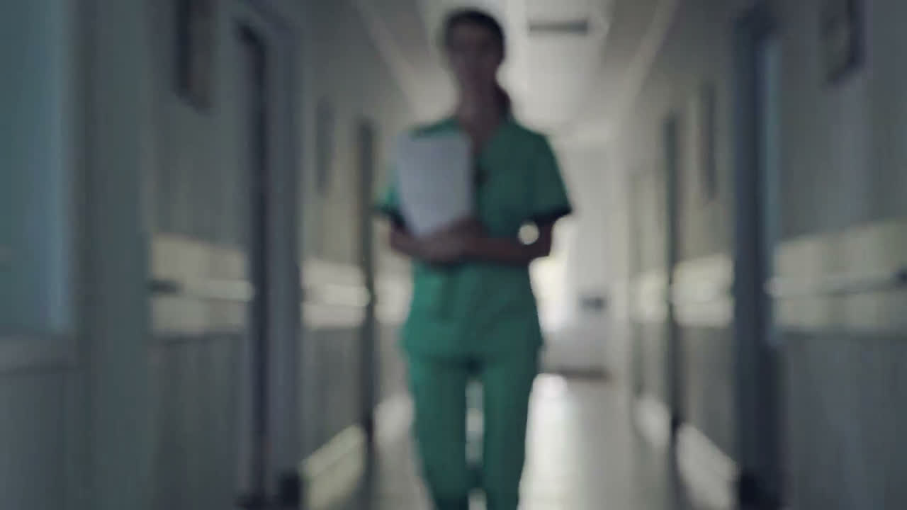 A nurse walking down a hospital corridor